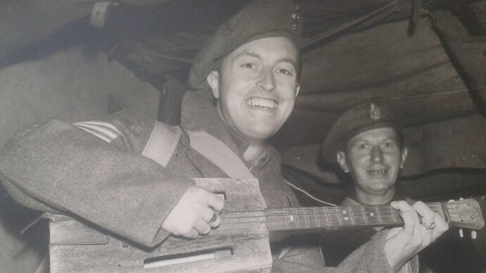 Tom with his ukulele after being repatriated to the UK